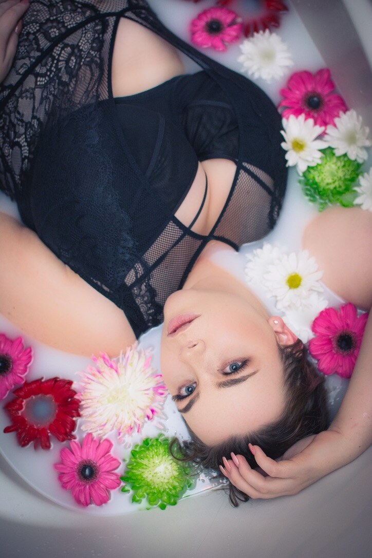 Natalia reclining among vivid flowers