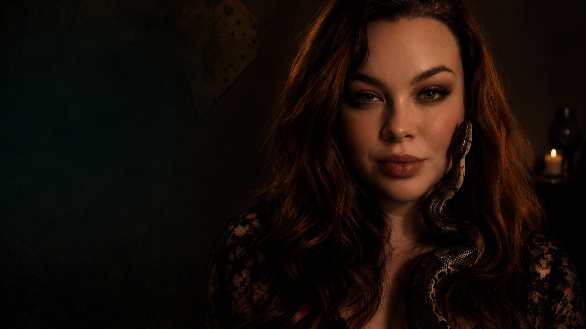 Natalia Rose in a candlelit portrait with a snake draped over her shoulder